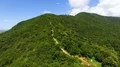 Aerial flight over beautiful mountain with art installation on top, nature 4k or 4k+ Resolution