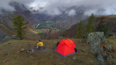 Aerial. flight over camping witn man towards a valley. view Video stock 82289720