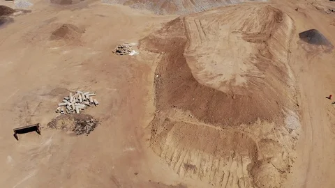 Aerial Flight Over a Construction Pit with Piles of Dirt Stock Footage 117024686