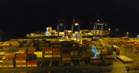 Aerial: flight over the container ship anchored in the port quay - 7 Stock Footage 98312058