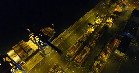 Aerial: flight over the container ship anchored in the port quay - 18 Stock-Footage 98312300