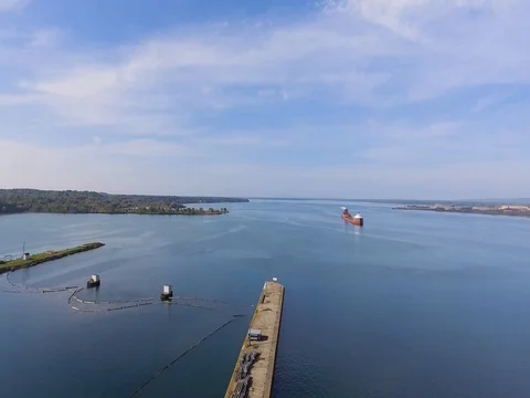 Aerial flight over edge of soo locks on St Marys River Stock Footage 80896491