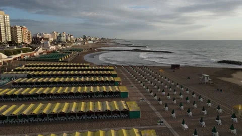 Aerial flight over empty yellow beach resort at sunrise. Stock Footage 152666707