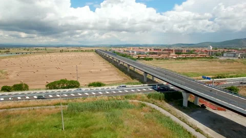 Aerial flight over the field with a view of the village and the bridge. Stock-Footage 87093409