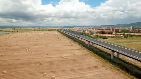Aerial flight over the field with a view of the village and the bridge. Stock Footage 87093426