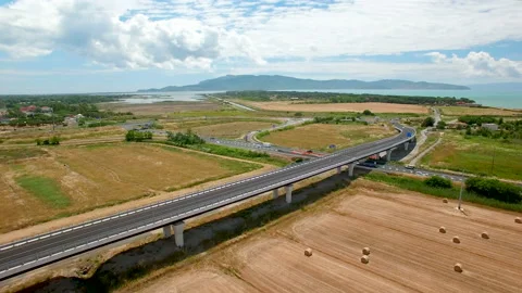 Aerial flight over the fields and next the highway. Stock Footage 87093070