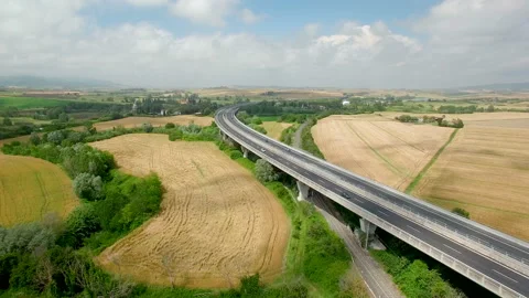Aerial flight over the fields and next the highway. Aerial view in Tuscany Stock-Footage 87093718