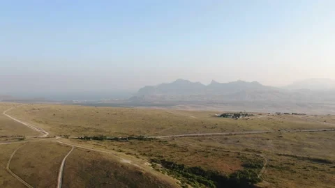 Aerial flight over a flat mountain overlooking the valley of the sea and the mou Stock-Footage 132191039