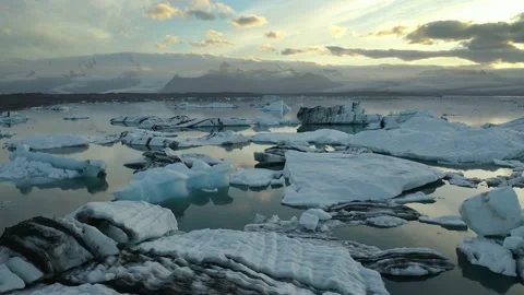 Aerial: Flight over floating Icebergs In Glacial lagoon lake Iceland Stock Footage 137315950