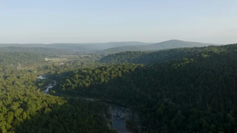 Aerial flight over forest, hills and a river Stock Footage