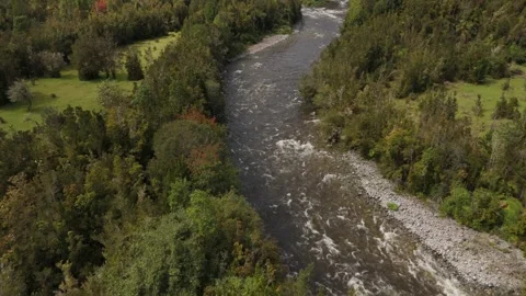 Aerial Flight Over Forest Tree Tops Towards Turbulent River in Lenca Chile Stock Footage 325245572