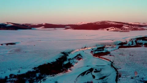 Aerial Flight Over Frozen River and Snow Covered Woodland Vídeo Stock 344955873
