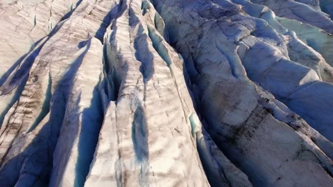 Aerial flight over a glacier with deep crevasses in Iceland Stock Footage 330264742