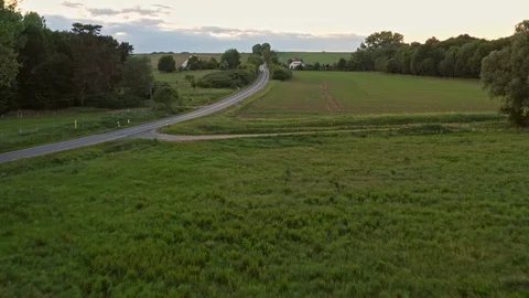 Aerial flight over green fields and road  in Germany Mecklenburg Vorpommern Stock Footage 116628787