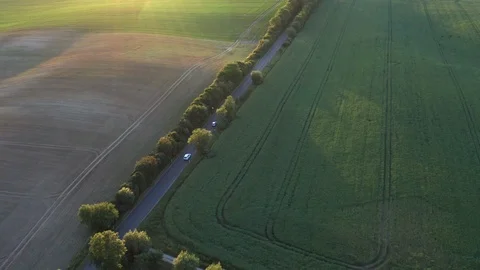 Aerial flight over green fields and road with driving cars in Germany 스톡 동영상 116628877
