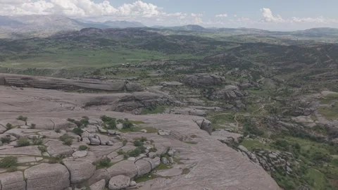 Aerial Flight Over Green Trees on Giant Rock Toward Valley Stock-Footage 344559168