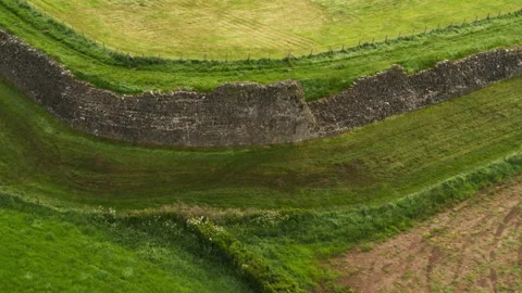 Aerial flight over Hadrian's Wall ruins in England countryside Video stock 336809610