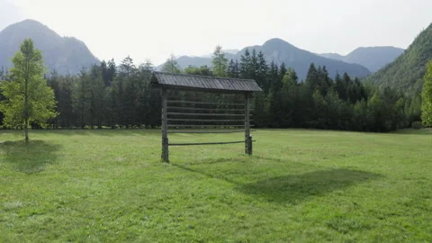 Aerial flight over a hayrack with a view over a mountain valley. Video stock 217374650