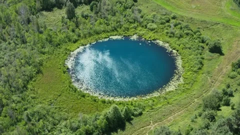 Aerial flight over lake perfect round shape. Ripple on water surface, summer day Video stock 136696853