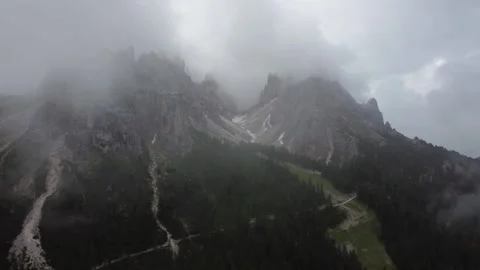 Aerial flight over larch trees in the beautiful Alps. High mountain peaks with Stock Footage 220334108
