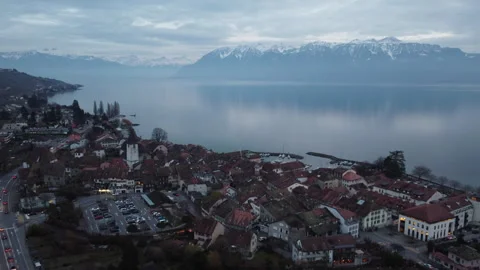 Aerial flight over Lutry old town and Lake Geneva with Alps, Switzerland 動画素材 328537121