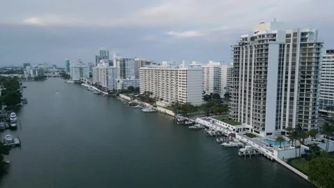 Aerial flight over a miami beach waterway skyline Stock Footage 346263623