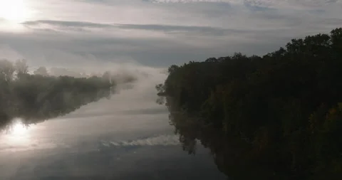 Aerial flight over a misty river in Wrocław on an autumn morning Stock Footage 346662196