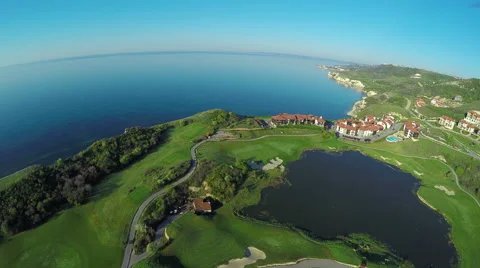 Aerial, Flight over modern golf resort close to sea coast Video stock 62486432