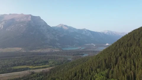 Aerial Flight Over a Mountain Forest and Valley Stock Footage 318818055