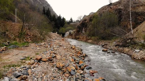 Aerial flight over a mountain river and its rocky shore. Taken by drone Stock-Footage 120792233