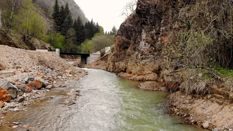 Aerial flight over a mountain river and its rocky shore. Taken by drone Stock Footage 120792267