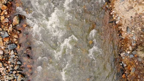 Aerial flight over a mountain river and its rocky shore. Taken by drone Stock Footage 120792279