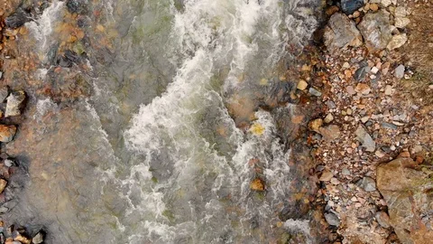 Aerial flight over a mountain river and its rocky shore. Taken by drone Stock Footage 120792286
