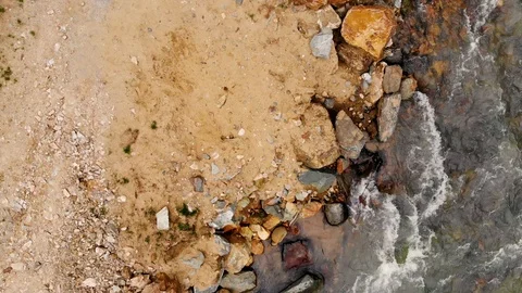 Aerial flight over a mountain river and its rocky shore. Taken by drone Stock Footage 120792306