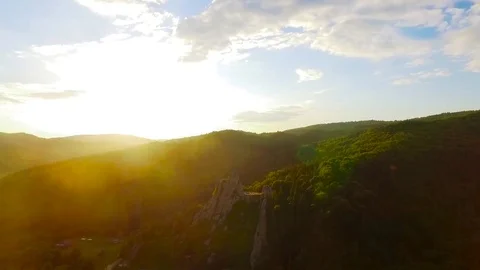 Aerial Flight over mountains with forests and hills in sunset Stock Footage 78008961