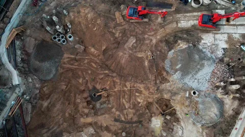 Aerial flight over new constructions site development where heavy machinery and Stock Footage 135539630