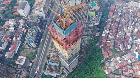 Aerial Flight Over a New Constructions Development Site with High Tower Cranes Stock Photos