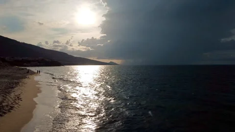 Aerial flight over ocean: Flying towards dark clouds on horizon Stock Footage 146291356