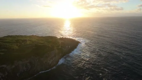 Aerial flight over ocean sunset sun Rocky Coastline Waves Crashing Cliffs Azores Stock Footage 221692575