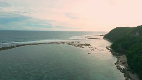 Aerial flight over the ocean with waves against the background of sunset at.. Stock Footage 239298980