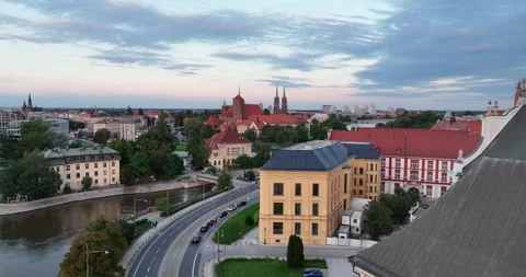 Aerial flight over Oder River toward Wrocław Cathedral at sunset Stock Footage 346662726