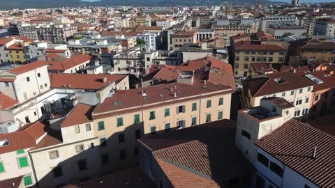 Aerial flight over old terracotta rooftops of Livorno, Italy at sunset Stock Footage 345128683