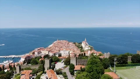 Aerial flight over a peninsula of red-roofed Venetian buildings and castle Stock Footage 127078454