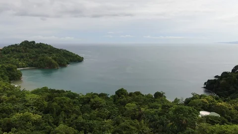 Aerial flight over rain forest covered bay on the Costa Rica pacific ocean Video stock 114537584