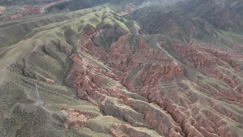 Aerial flight over red eroded canyon hills, Kok-Moinok Canyons, Kyrgyzstan Видео 347239779