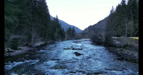 Aerial Flight Over a River in the Austrian Alps on a Clear Winter Day Stock Footage 288065695