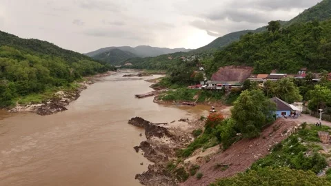 Aerial Flight Over River Bend Toward Riverside Village, Luang Prabang Stock-Footage 347420947
