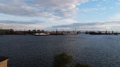 Aerial flight over river on which floating yacht and construction dock crane Stock Footage 96118611