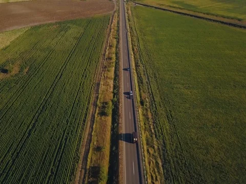 Aerial Flight over the road between fields.  Aerial drone footage 4k Stock Footage 78414063