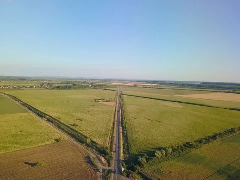Aerial Flight over the road between fields.  Aerial drone footage 4k Stock Footage 78560431